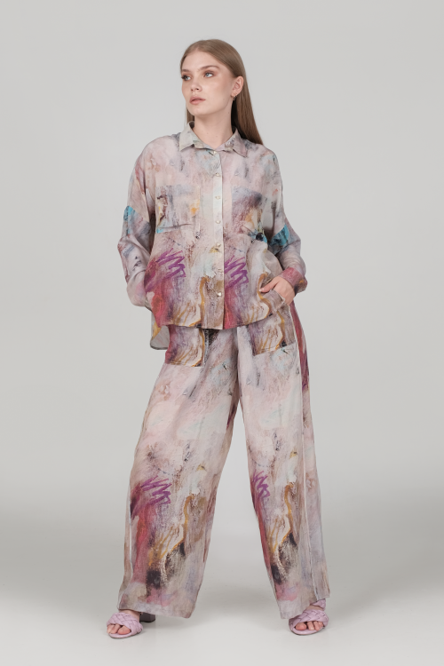 Pants produced in a silk which has been printed from a painting